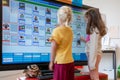 ARNHEM / NETHERLANDS - AUGUST 28 2020: Children in school standing in front of a touch screen monitor