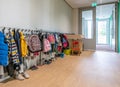 ARNHEM / NETHERLANDS - AUGUST 28 2020: Cloakroom with coats and backpacks in a school building for toddlers and young children