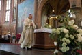 Bishop is approaching the altar in a catholic church