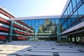 View on large inner courtyard of modern town hall with reflecting glass facade and red awnings Royalty Free Stock Photo