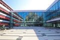 View on large inner courtyard of modern town hall with reflecting glass facade and red awnings Royalty Free Stock Photo