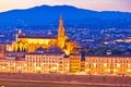 Arno river waterfront and illuminated church in Florence evening Royalty Free Stock Photo