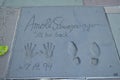 Arnold Schwarzenegger cast place hand prints in cement at Hollywood`s Chinese Theatre, Los Angeles, California, United States of A