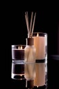 Aroma diffuser and scented candles on table with reflectio. Romantic setting Royalty Free Stock Photo