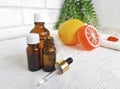 Aroma essential oil bottles with orange citrus soap on white wooden background. Royalty Free Stock Photo