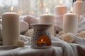 Aroma lamp with essential oil, aromatherapy at home, burning candle, dropping essential oil. Concept of home relaxation