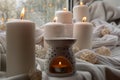 Aroma lamp with essential oil, aromatherapy at home, burning candle, dropping essential oil. Concept of home relaxation