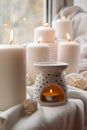 Aroma lamp with essential oil, aromatherapy at home, burning candle, dropping essential oil. Concept of home relaxation