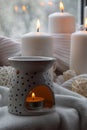 Aroma lamp with essential oil, aromatherapy at home, burning candle, dropping essential oil. Concept of home relaxation