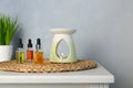 Aroma lamp and essential oils on white table Royalty Free Stock Photo