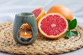 Aroma lamp with grapefruit essential oil, spa background, horizontal