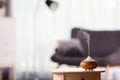 Aroma oil diffuser on table against blurred background