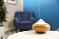 Aroma oil diffuser on white table at home. Air freshener Royalty Free Stock Photo