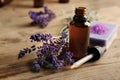 Aroma oil and lavender flowers on wooden background Royalty Free Stock Photo
