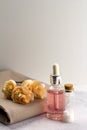 Aroma oil sea salt bottles fresh flowers on towel marble table Royalty Free Stock Photo