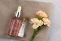 Aroma oil sea salt bottles fresh flowers on towel marble table Royalty Free Stock Photo