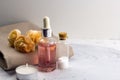 Aroma oil sea salt bottles fresh flowers on towel marble table Royalty Free Stock Photo