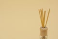 Rattan sticks for scenting the room on a beige background