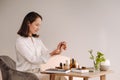 The aromatherapist girl is sitting in her office. there are essential oils on the table Royalty Free Stock Photo