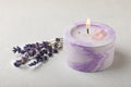 Aromatherapy concept, candle with lavender flowers.