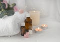Aromatherapy concept with essential oil bottle, sea salt, burning candles and towel. Royalty Free Stock Photo