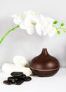 Aromatherapy diffusor oil with towel, stones and orchid. Relax concept