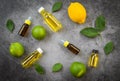 Aromatherapy herbal oil bottles aroma with lemon and lime leaves herbal formulations top view - Essential oils natural on black Royalty Free Stock Photo