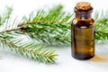 Aromatherapy with organic spruce oils in glass bottles on white