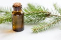 Aromatherapy with organic spruce oils in glass bottles on white table background