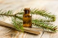 Aromatherapy with organic spruce oils in glass bottles on wooden table background