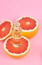 Aromatherapy - Pure essential oil in bottle with fresh grapefruit halves