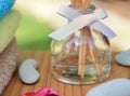 Aromatherapy reed difuser bottle in a beautiful outdoor setting in morning sunlight