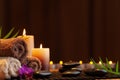 Aromatherapy, spa, beauty treatment and wellness background with massage stone, orchid flowers, towels and burning candles