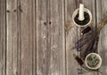 The border is made of bunches of dried herbs lavender and sage, small bottles of essential oils, mortar and pestle on a wooden bac Royalty Free Stock Photo