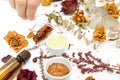 Aromatic botanical cosmetics. Dried herbs flowers mixture, facial mud clay mask, oils, applying brush. Holistic herbal skincare