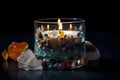 aromatic candle surrounded by crystals, stones and other natural elements