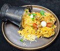 Aromatic Chicken Biryani Spilling from Black Container Royalty Free Stock Photo