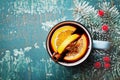 Aromatic christmas mulled wine or gluhwein with spices and orange slices on vintage teal table top view.Traditional winter drink Royalty Free Stock Photo