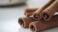 Close-up of aromatic cinnamon sticks on a white surface with soft lighting and copy space Royalty Free Stock Photo