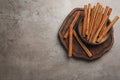 Aromatic cinnamon sticks on grey stone table, flat lay. Space for text Royalty Free Stock Photo