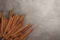Aromatic cinnamon sticks on grey stone table, flat lay. Space for text Royalty Free Stock Photo