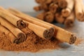 Aromatic cinnamon sticks and powder on grey wooden table, closeup Royalty Free Stock Photo