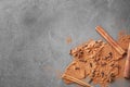 Aromatic cinnamon sticks, powder and spices on grey background Royalty Free Stock Photo