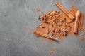 Aromatic cinnamon sticks, powder and spices on grey background Royalty Free Stock Photo