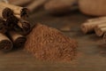Aromatic cinnamon sticks and powder on wooden table, closeup Royalty Free Stock Photo