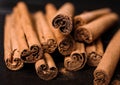 Aromatic cinnamon sticks and spoon with powder on wooden table, closeup Royalty Free Stock Photo