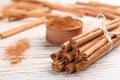 Aromatic cinnamon sticks on white wooden table, closeup. Space for text Royalty Free Stock Photo