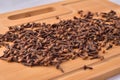 Aromatic cloves magnified on a wooden kitchen board, spices and aromas. Large depth of field