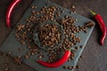 Aromatic coffee beans in a metal Turkish bowl, anise with bitter hot chili pepper on a black background 2 Royalty Free Stock Photo