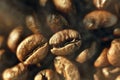 Aromatic coffee beans are roasted with smoke and steam. Macro photo of grain close up Royalty Free Stock Photo